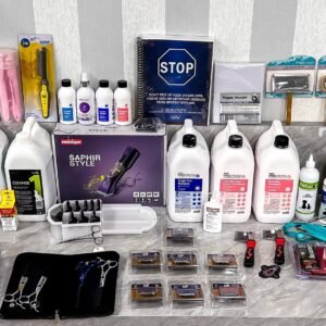 An Ultimate Dog Grooming Starter Bundle is organized on a marble countertop, featuring shampoos, trimmers, brushes, combs, scissor sets, and grooming tools. A "STOP" sign and several packaging boxes are also present.