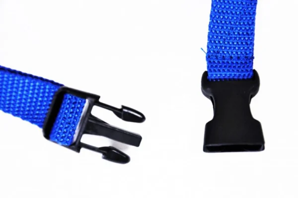 K9 Trailer Rentals Close-up of two ends of the Quick Muzzle for Dogs’ blue nylon strap with a black plastic side-release buckle, showing the prong and slot ends against a white background.