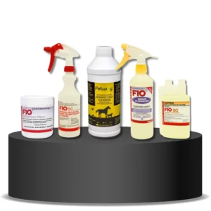 K9 Trailer Rentals Five Trailer Cleaning Bundle products—including wipes, spray bottles, and a liquid cleanser—are displayed on a round, black podium with a white background. The products feature red, yellow, and white labels.
